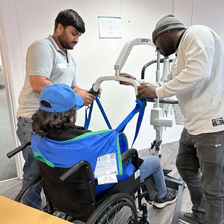man being listed into a care home hoist